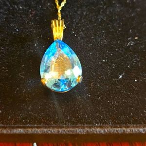 21 Carat Blue Topaz 14K Gold Pendant.